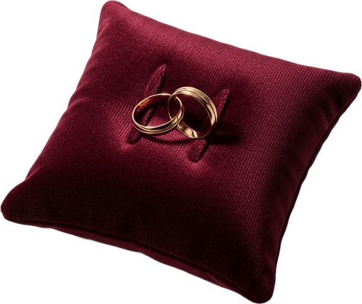 Two gold wedding bands on an oxblood velvet pillow